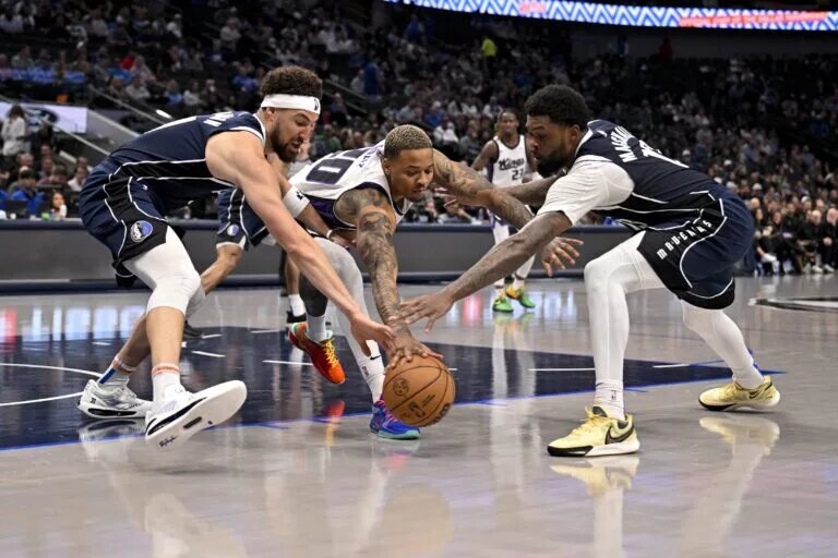 Mar 3, 2025; Dallas, Texas, USA; Dallas Mavericks guard Klay Thompson (31) and forward Naji Marshall (13) and Sacramento Kings guard Markelle Fultz (20) battle for the loose ball during the second half at the American Airlines Center.