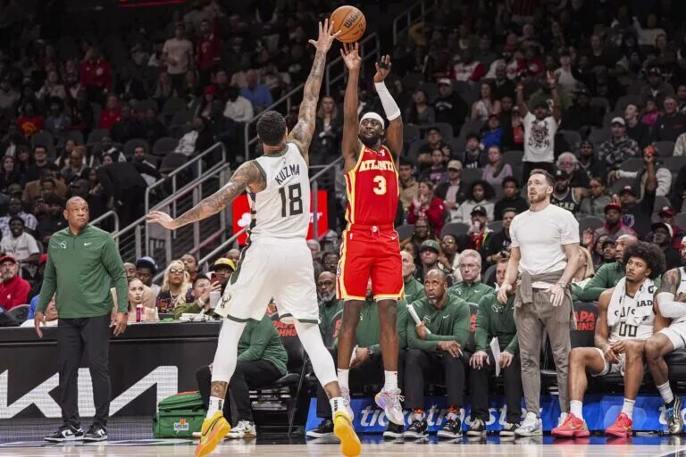 Atlanta Hawks guard Caris LeVert (3) shoots over Milwaukee Bucks forward Kyle Kuzma (18) during the second half at State Farm Arena.
