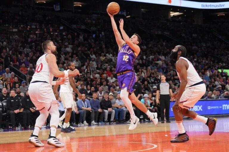 Mar 4, 2025; Phoenix, Arizona, USA; Phoenix Suns guard Collin Gillespie (12) shoots against the LA Clippers during the second half at PHX Center. Mandatory Credit: Joe Camporeale-Imagn Images