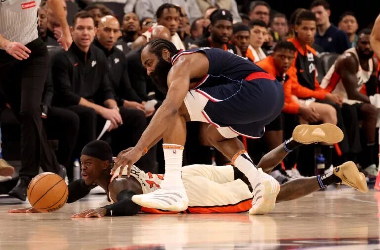 Mar 5, 2025; Inglewood, California, USA; Detroit Pistons guard Dennis Schroder (17) dives for a loose ball against LA Clippers guard James Harden (1) during the fourth quarter at Intuit Dome.
