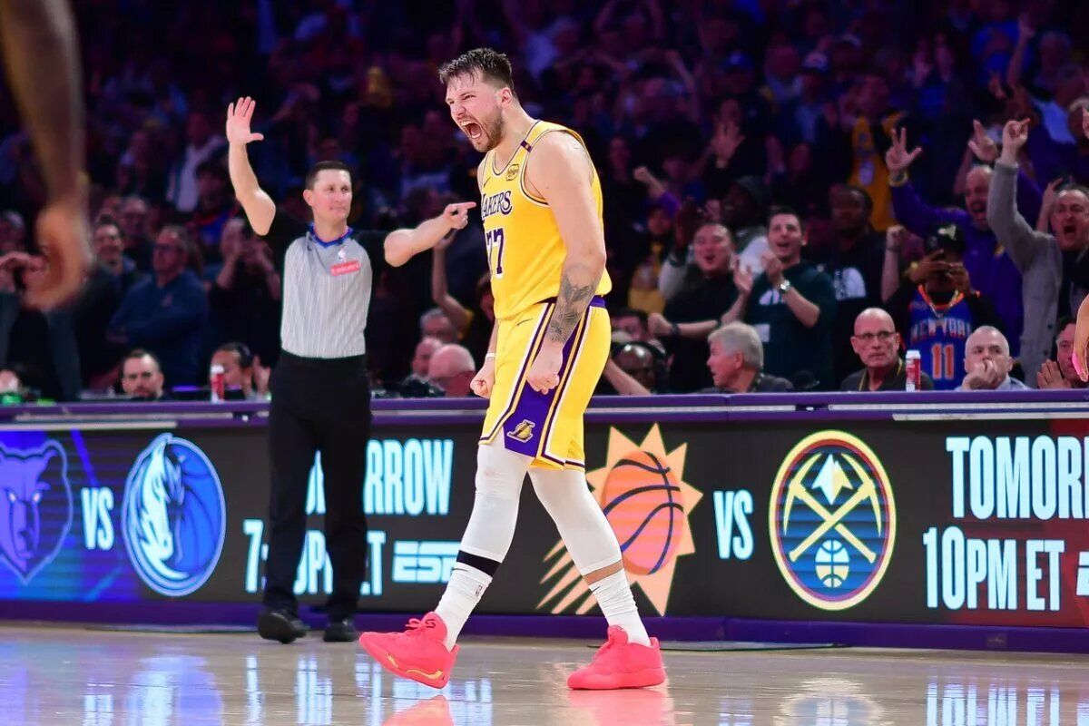 Mar 6, 2025; Los Angeles, California, USA; Los Angeles Lakers guard Luka Doncic (77) reacts after scoring a basket against the New York Knicks during overtime at Crypto.com Arena. Mandatory Credit: Gary A. Vasquez-Imagn Images