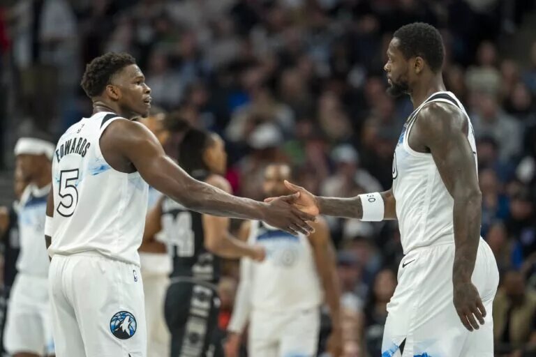 Mar 9, 2025; Minneapolis, Minnesota, USA; Minnesota Timberwolves guard Anthony Edwards (5) shakes hands with forward Julius Randle (30) after making a shot against the San Antonio Spurs in the first half at Target Center. Mandatory Credit: Jesse Johnson-Imagn Images