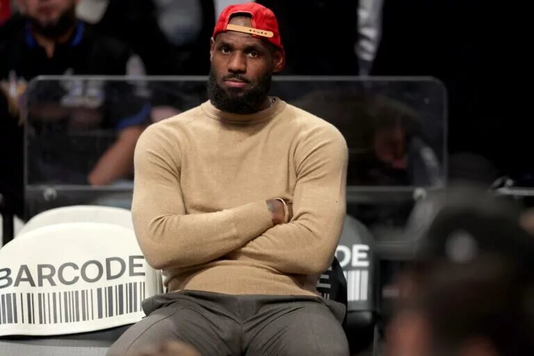 Mar 10, 2025; Brooklyn, New York, USA; Los Angeles Lakers forward LeBron James (23) watches from the bench during the fourth quarter against the Brooklyn Nets at Barclays Center. Mandatory Credit: Brad Penner-Imagn Images