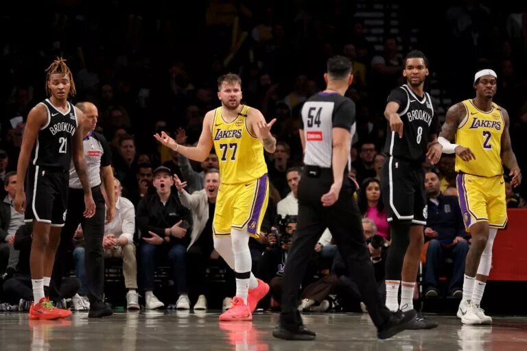 Mar 10, 2025; Brooklyn, New York, USA; Los Angeles Lakers guard Luka Doncic (77) reacts towards referee Ray Acosta (54) during the fourth quarter against the Brooklyn Nets at Barclays Center. Mandatory Credit: Brad Penner-Imagn Images