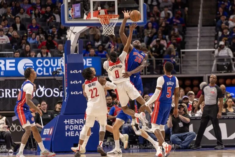 Mar 11, 2025; Detroit, Michigan, USA; Detroit Pistons center Isaiah Stewart (28) blocks a shot attempt by Washington Wizards guard Bub Carrington (8) during the second half at Little Caesars Arena. Mandatory Credit: David Reginek-Imagn Images