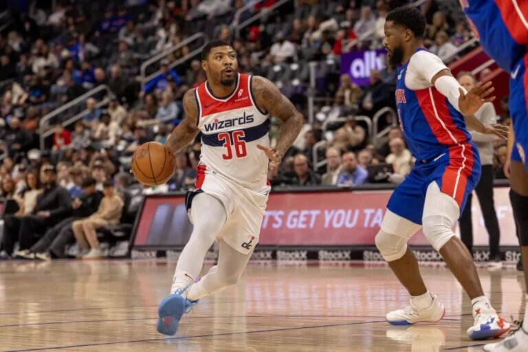 Mar 11, 2025; Detroit, Michigan, USA; Washington Wizards guard Marcus Smart (36) drives to the basket as Detroit Pistons guard Malik Beasley (5) defends during the first half at Little Caesars Arena. Mandatory Credit: David Reginek-Imagn Images