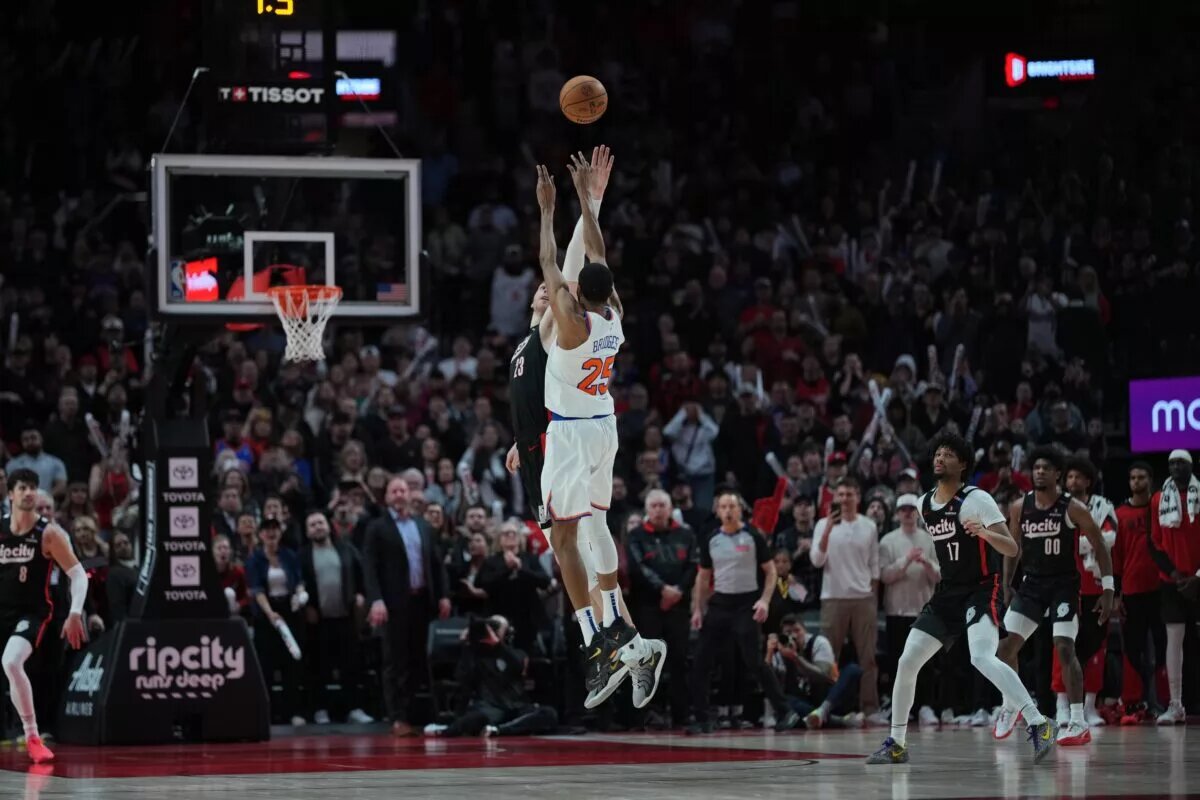 Mar 12, 2025; Portland, Oregon, USA; New York Knicks small forward Mikal Bridges (25) shoots the game-winning basket over Portland Trail Blazers center Donovan Clingan (23) during overtime at Moda Center. Mandatory Credit: Soobum Im-Imagn Images