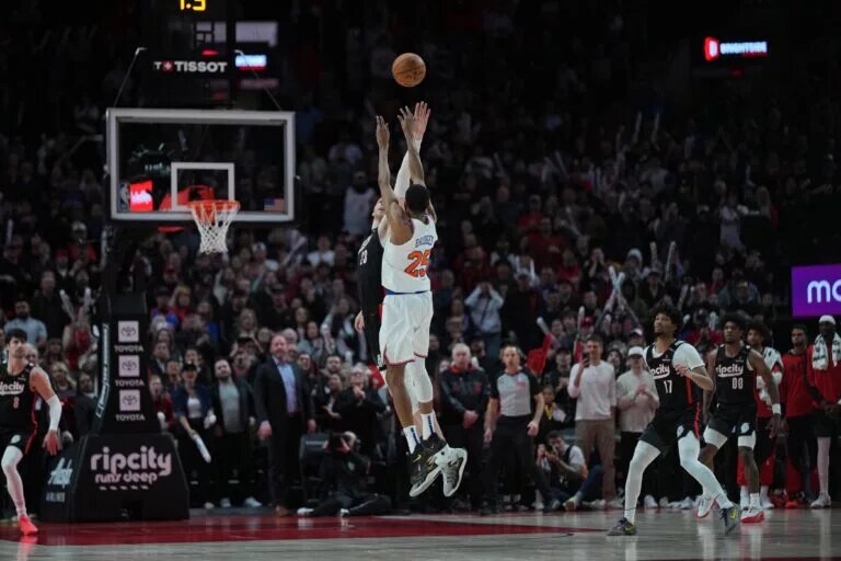 Mar 12, 2025; Portland, Oregon, USA; New York Knicks small forward Mikal Bridges (25) shoots the game-winning basket over Portland Trail Blazers center Donovan Clingan (23) during overtime at Moda Center. Mandatory Credit: Soobum Im-Imagn Images