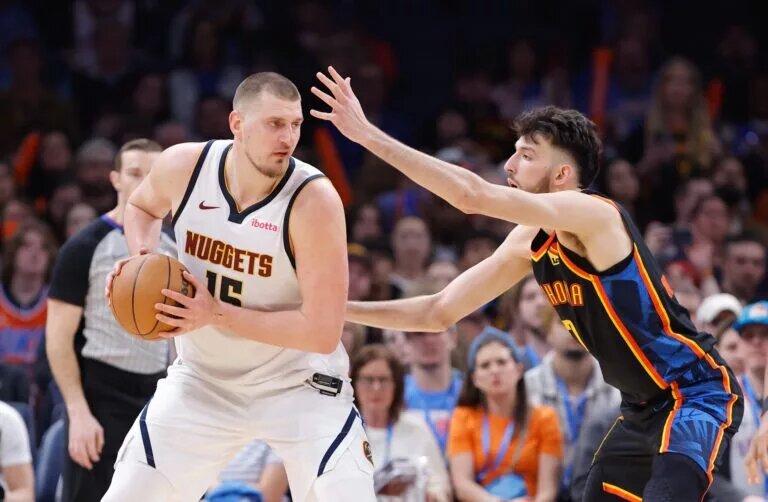 Oklahoma City Thunder forward Chet Holmgren (7) defends Denver Nuggets center Nikola Jokic