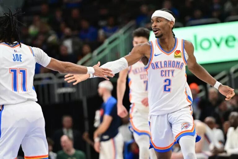 Mar 16, 2025; Milwaukee, Wisconsin, USA; Oklahoma City Thunder guard Shai Gilgeous-Alexander (2) celebrates with guard Isaiah Joe (11) after score in the fourth quarter against the Milwaukee Bucks at Fiserv Forum. Mandatory Credit: Benny Sieu-Imagn Images