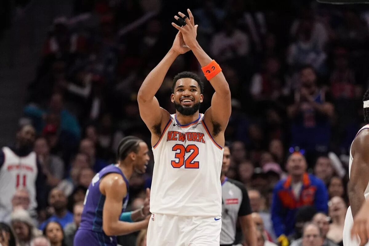 Mar 20, 2025; Charlotte, North Carolina, USA; New York Knicks center Karl-Anthony Towns (32) reacts to a foul call against the Charlotte Hornets during the second half at Spectrum Center. Mandatory Credit: Jim Dedmon-Imagn Images