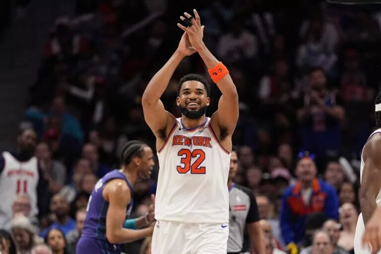 Mar 20, 2025; Charlotte, North Carolina, USA; New York Knicks center Karl-Anthony Towns (32) reacts to a foul call against the Charlotte Hornets during the second half at Spectrum Center. Mandatory Credit: Jim Dedmon-Imagn Images