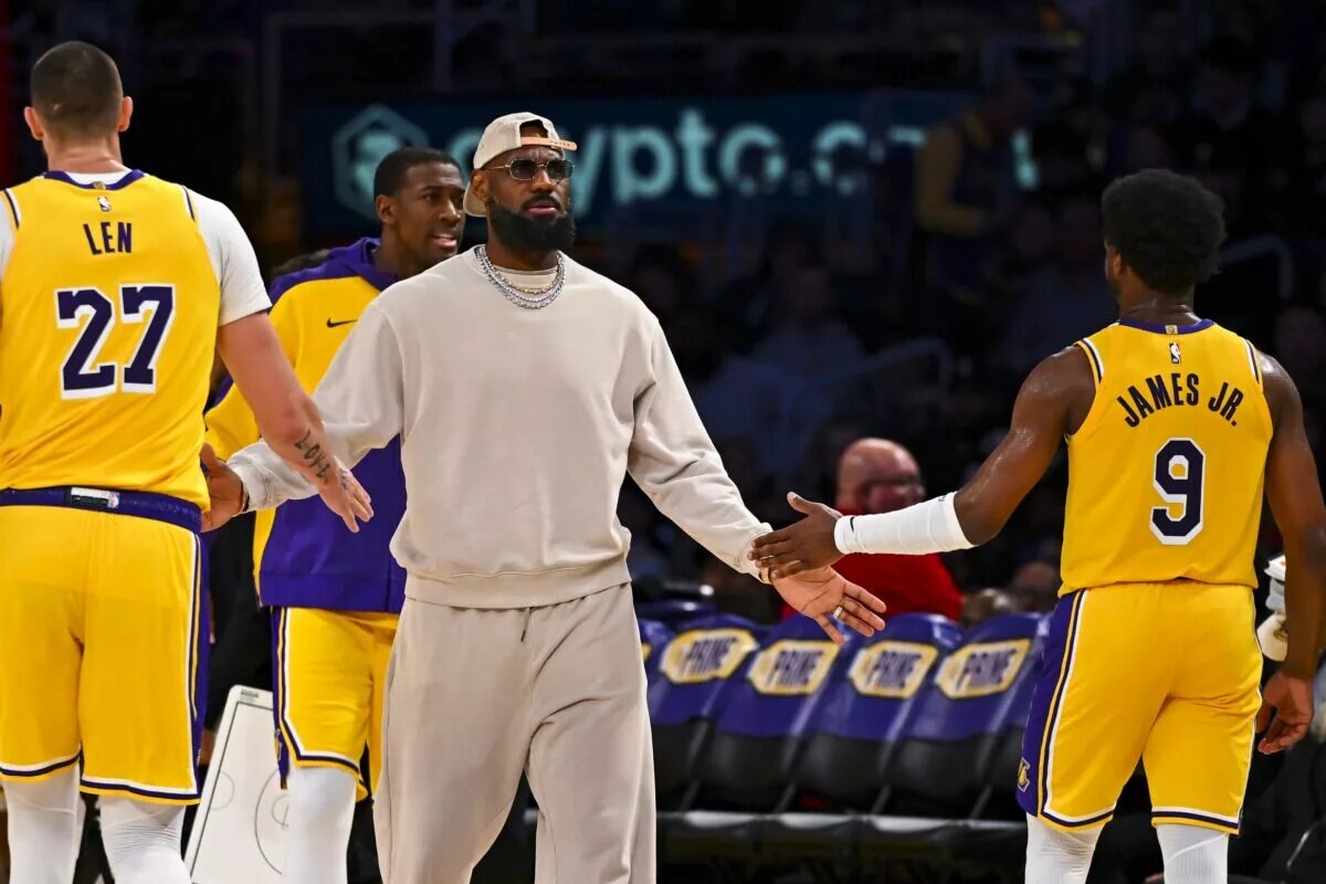 Los Angeles Lakers forward LeBron James (23) fives guard Bronny James (9)
