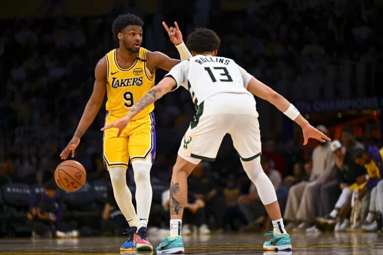 Mar 20, 2025; Los Angeles, California, USA; Los Angeles Lakers guard Bronny James (9) looks to pass against Milwaukee Bucks guard Ryan Rollins (13) during the second half at Crypto.com Arena. Mandatory Credit: Jonathan Hui-Imagn Images JJ Redick