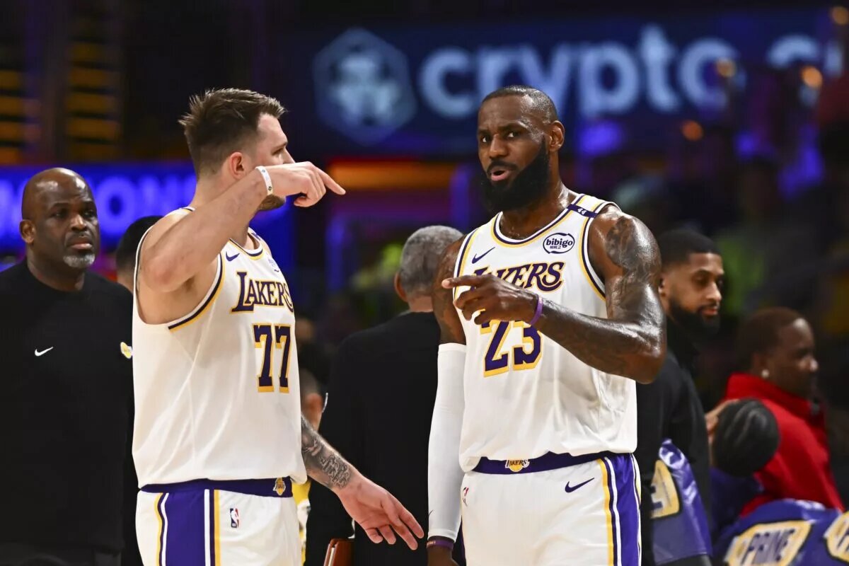 Los Angeles, California, USA; Los Angeles Lakers guard Luka Doncic (77) and Los Angeles Lakers forward LeBron James (23) on the sidelines against the Chicago Bulls during the first half at Crypto.com Arena.