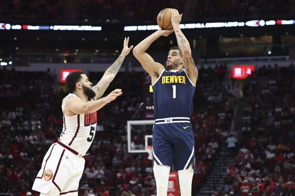 Mar 23, 2025; Houston, Texas, USA; Denver Nuggets forward Michael Porter Jr. (1) shoots the ball as Houston Rockets guard Fred VanVleet (5) defends during the third quarter at Toyota Center. Mandatory Credit: Troy Taormina-Imagn Images