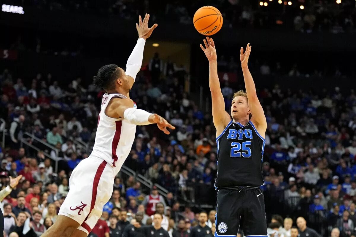 Mar 27, 2025; Newark, NJ, USA; Brigham Young Cougars guard Dawson Baker (25) shoots the ball against Alabama Crimson Tide forward Jarin Stevenson (15) during the second half during an East Regional semifinal of the 2025 NCAA tournament at Prudential Center. Mandatory Credit: Robert Deutsch-Imagn Images