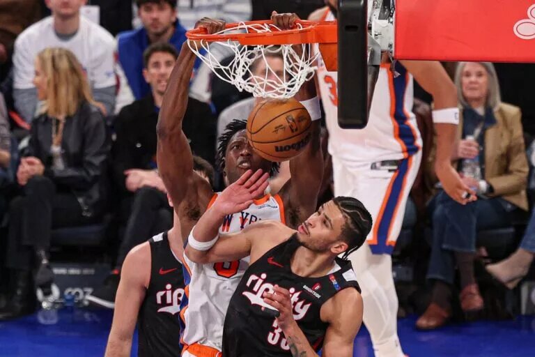 Mar 30, 2025; New York, New York, USA; New York Knicks forward OG Anunoby (8) dunks the ball against Portland Trail Blazers forward Toumani Camara (33) during the second half at Madison Square Garden.
