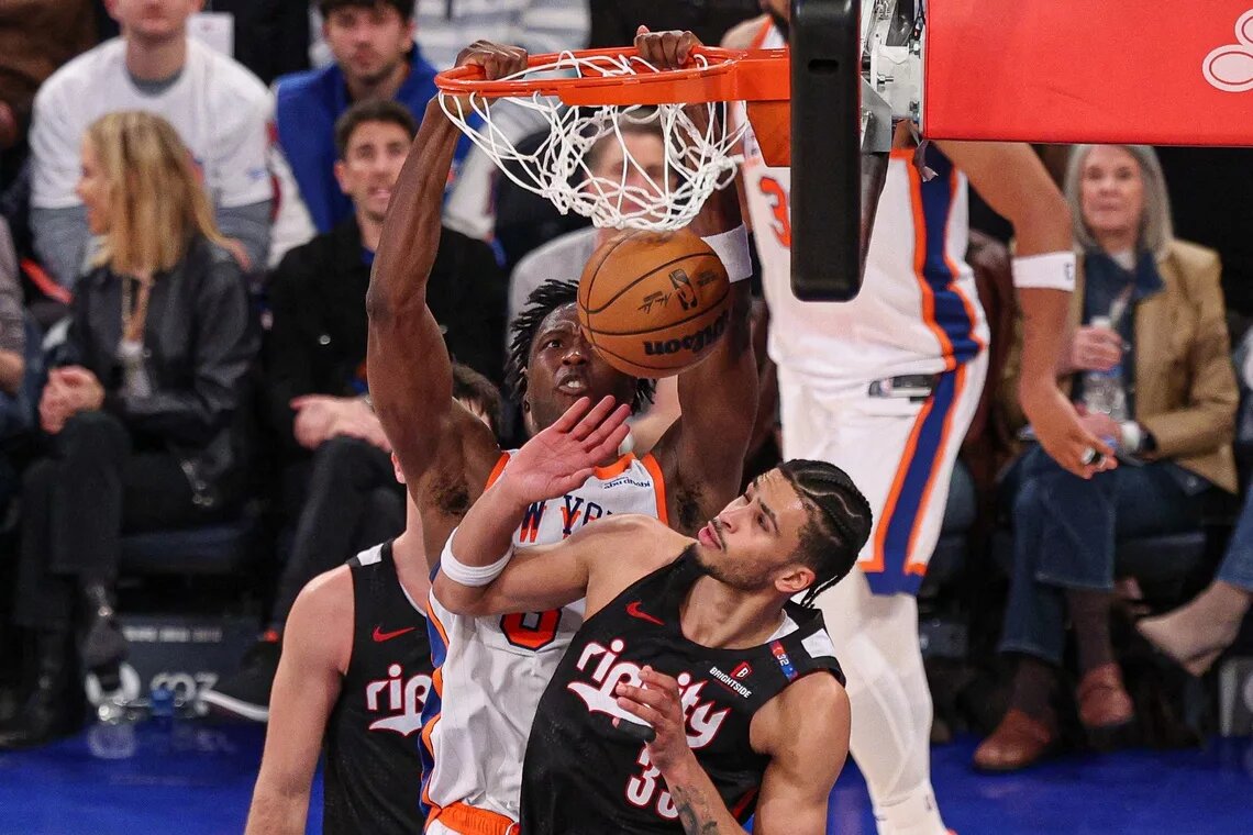 Mar 30, 2025; New York, New York, USA; New York Knicks forward OG Anunoby (8) dunks the ball against Portland Trail Blazers forward Toumani Camara (33) during the second half at Madison Square Garden.