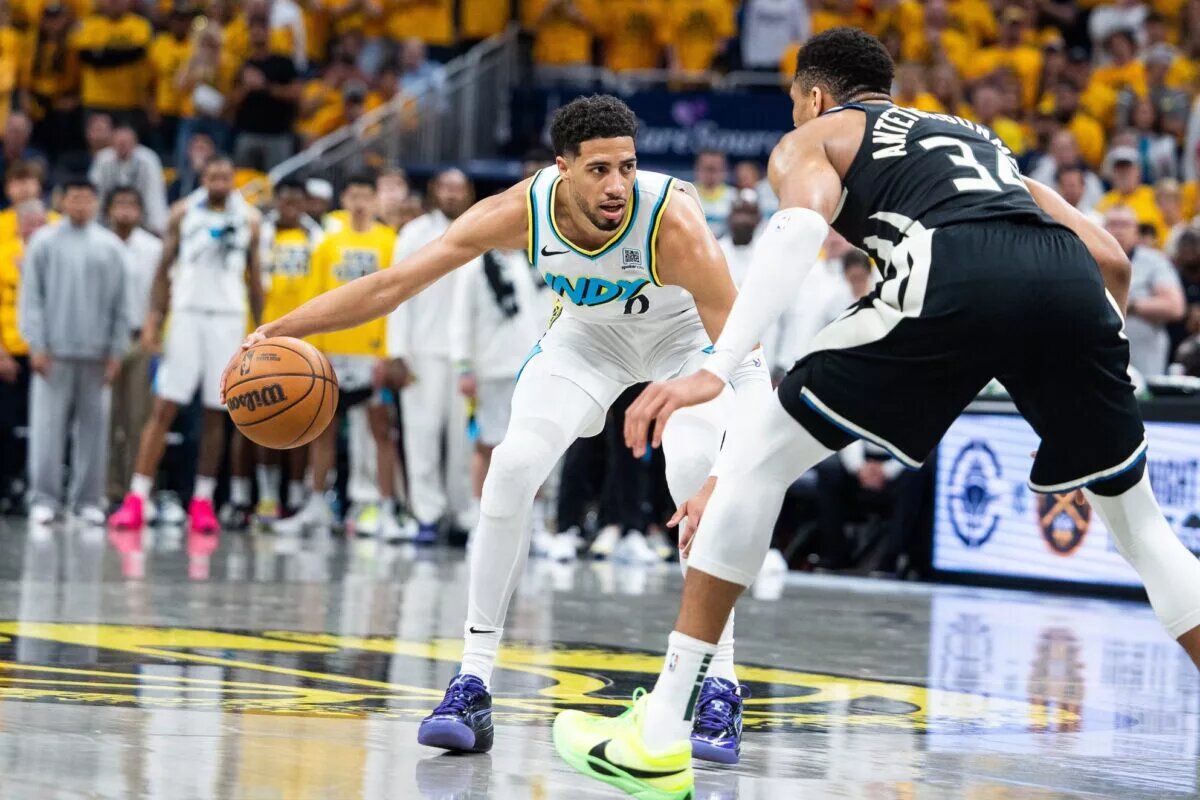 Indiana Pacers guard Tyrese Haliburton (0) dribbles the ball while Milwaukee Bucks forward Giannis Antetokounmpo (34) defends
