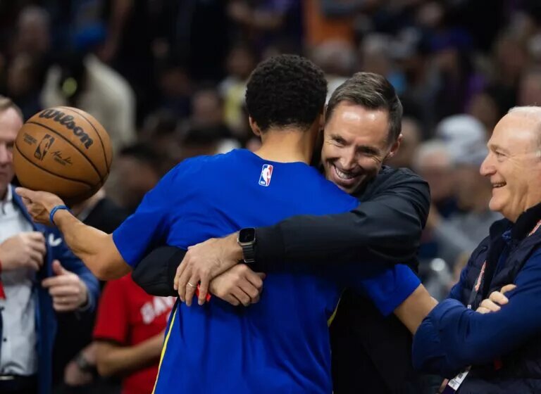 Golden State Warriors guard Stephen Curry (left) greets Steve Nash