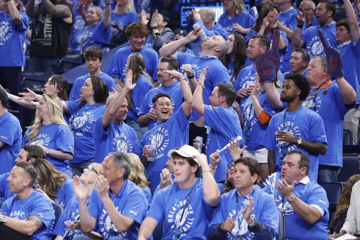 May 9, 2024; Oklahoma City, Oklahoma, USA; Oklahoma City Thunder fans cheer as their team scores against the Dallas Mavericks during the second quarter of game two of the second round for the 2024 NBA playoffs at Paycom Center. Mandatory Credit: Alonzo Adams-USA TODAY Sports