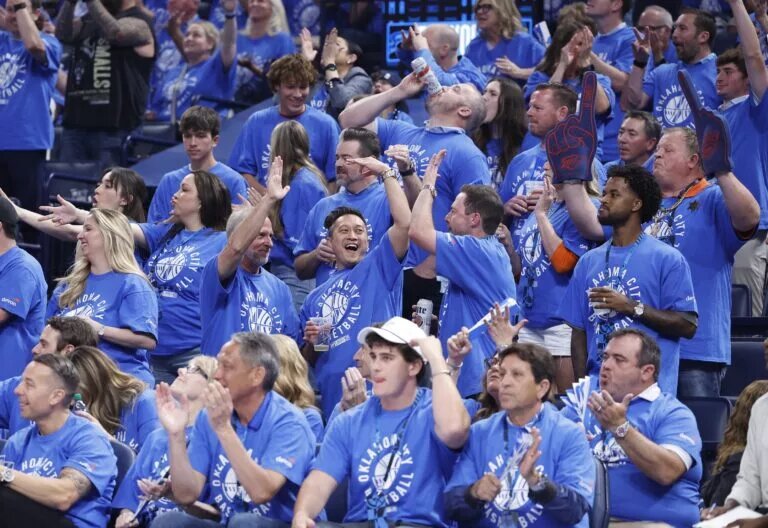 May 9, 2024; Oklahoma City, Oklahoma, USA; Oklahoma City Thunder fans cheer as their team scores against the Dallas Mavericks during the second quarter of game two of the second round for the 2024 NBA playoffs at Paycom Center. Mandatory Credit: Alonzo Adams-USA TODAY Sports