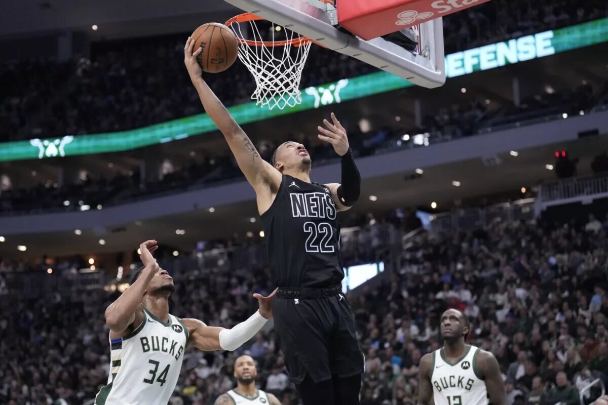 Jan 2, 2025; Milwaukee, Wisconsin, USA; Brooklyn Nets forward Jalen Wilson (22) puts up a shot against Milwaukee Bucks forward Giannis Antetokounmpo (34) and Milwaukee Bucks forward Taurean Prince (12) in the second half at Fiserv Forum. Mandatory Credit: Michael McLoone-Imagn Images