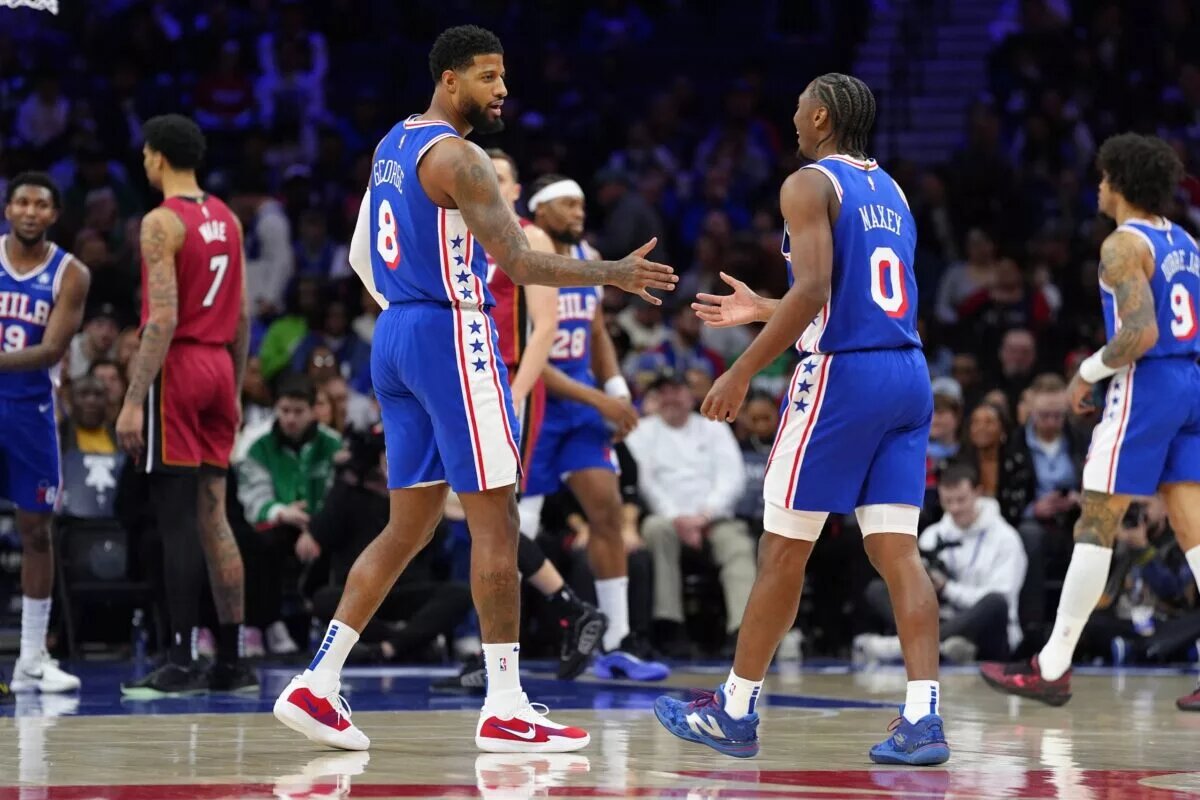 Philadelphia 76ers forward Paul George (8) reacts with guard Tyrese Maxey
