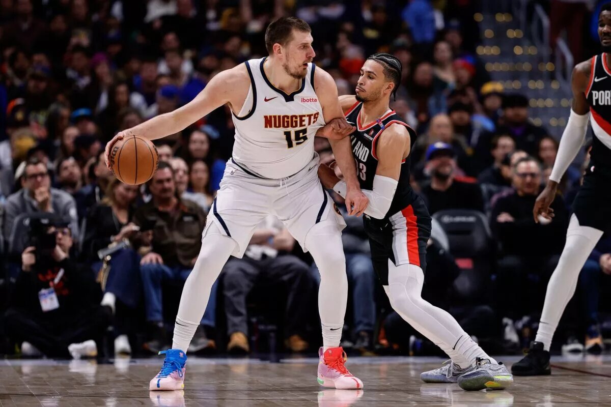 Feb 10, 2025; Denver, Colorado, USA; Denver Nuggets center Nikola Jokic (15) controls the ball as Portland Trail Blazers forward Toumani Camara (33) guards in the second quarter at Ball Arena. Mandatory Credit: Isaiah J. Downing-Imagn Images