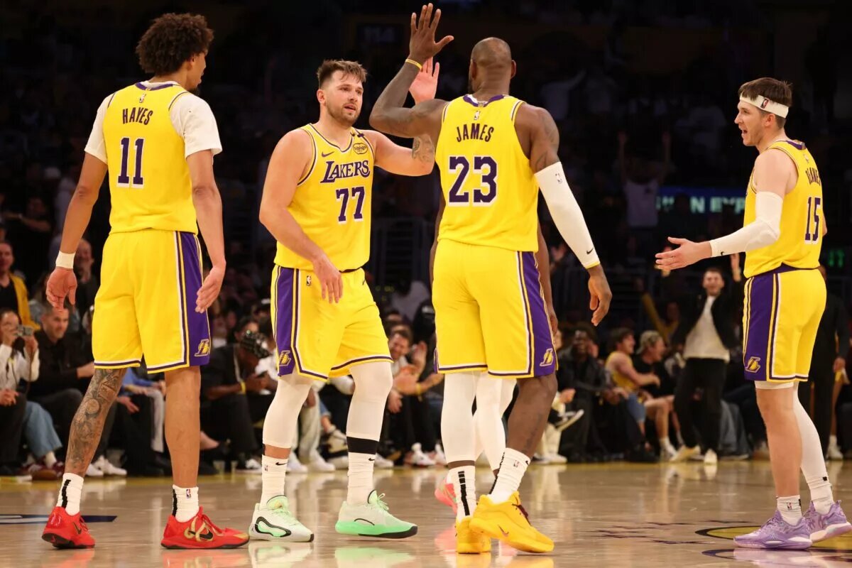 Los Angeles Lakers guard Luka Doncic (77) celebrates with forward LeBron James