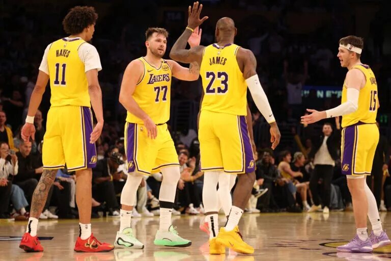 Los Angeles Lakers guard Luka Doncic (77) celebrates with forward LeBron James