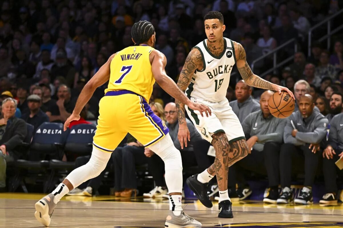 Mar 20, 2025; Los Angeles, California, USA; Milwaukee Bucks forward Kyle Kuzma (18) dribbles the ball against Los Angeles Lakers guard Gabe Vincent (7) during the first half at Crypto.com Arena.