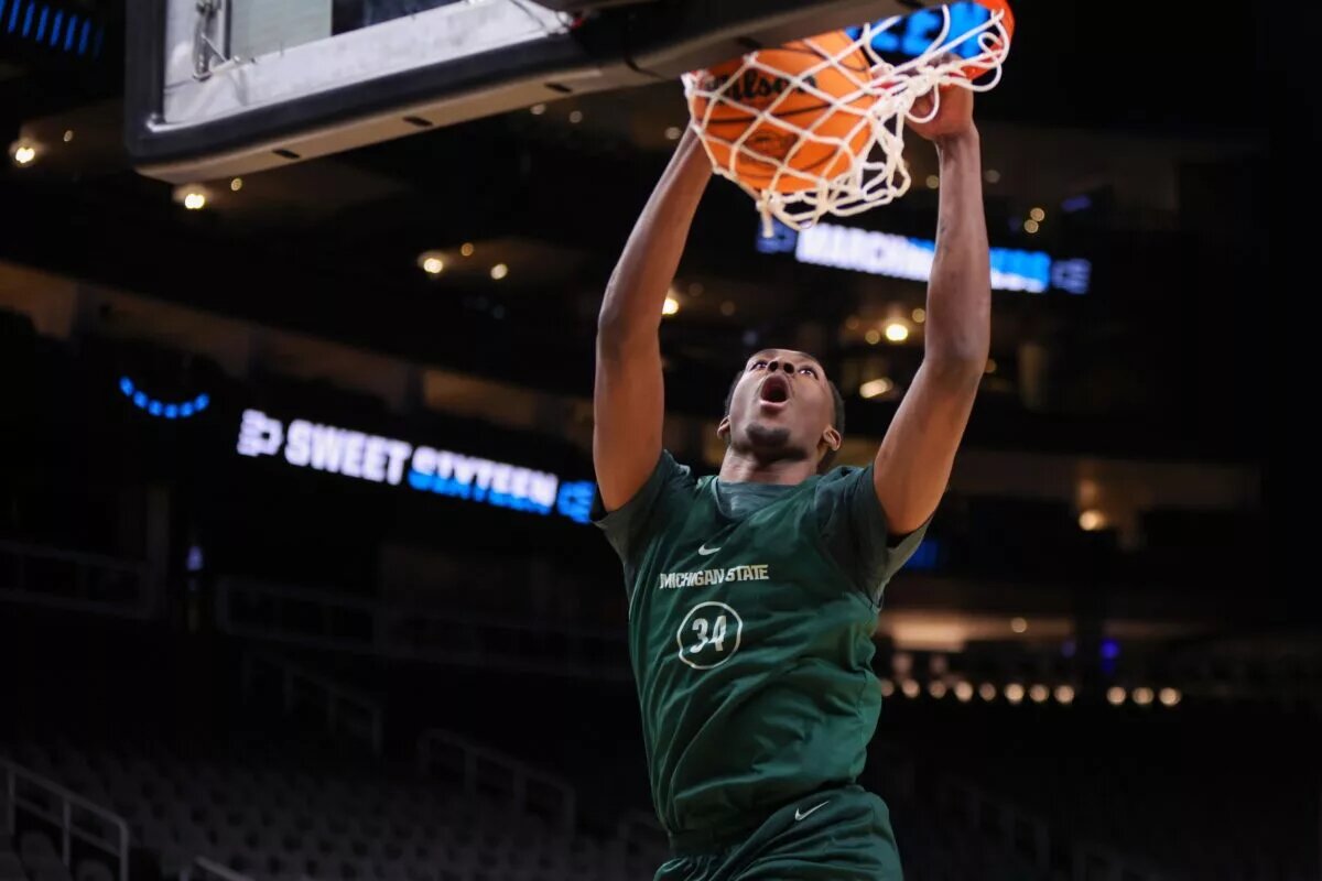 Mar 27, 2025; Atlanta, GA, USA; Michigan State Spartans forward Xavier Booker (34) dunks during NCAA Tournament South Regional Practice at State Farm Arena. Mandatory Credit: Brett Davis-Imagn Images