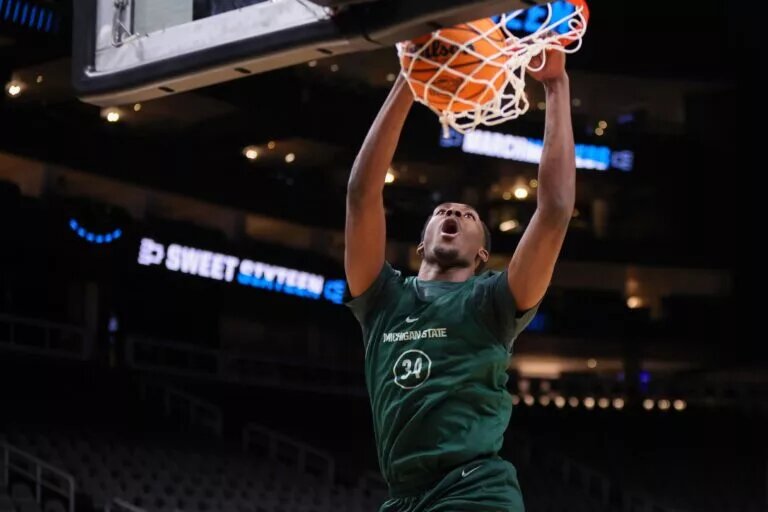 Mar 27, 2025; Atlanta, GA, USA; Michigan State Spartans forward Xavier Booker (34) dunks during NCAA Tournament South Regional Practice at State Farm Arena. Mandatory Credit: Brett Davis-Imagn Images