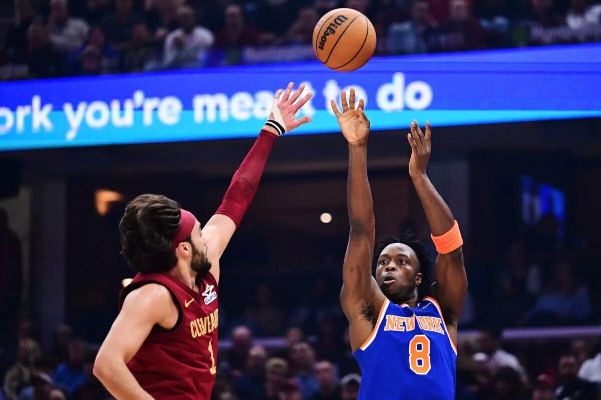 Apr 2, 2025; Cleveland, Ohio, USA; New York Knicks forward OG Anunoby (8) shoots over the defense of Cleveland Cavaliers guard Max Strus (1) during the first quarter at Rocket Arena. Mandatory Credit: Ken Blaze-Imagn Images