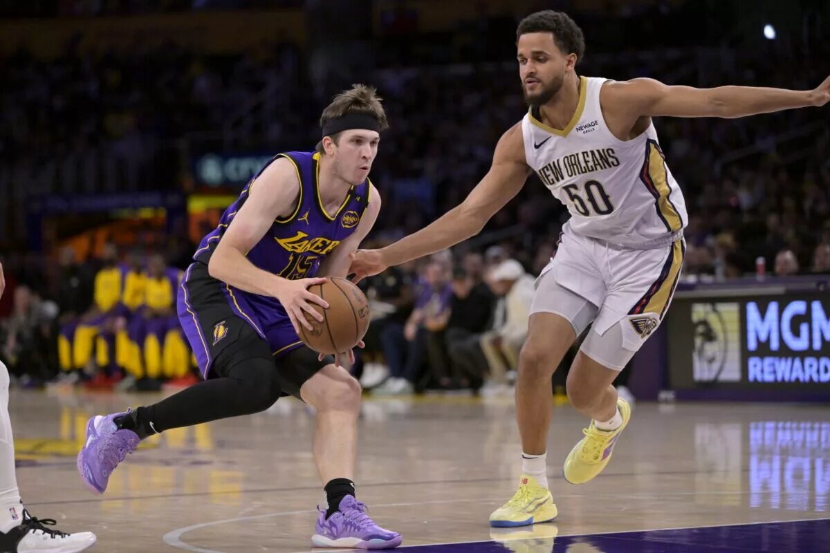 Apr 4, 2025; Los Angeles, California, USA; Los Angeles Lakers guard Austin Reaves (15) is defended by New Orleans Pelicans forward Jeremiah Robinson-Earl (50) as he drives to the basket in the first half at Crypto.com Arena. Mandatory Credit: Jayne Kamin-Oncea-Imagn Images