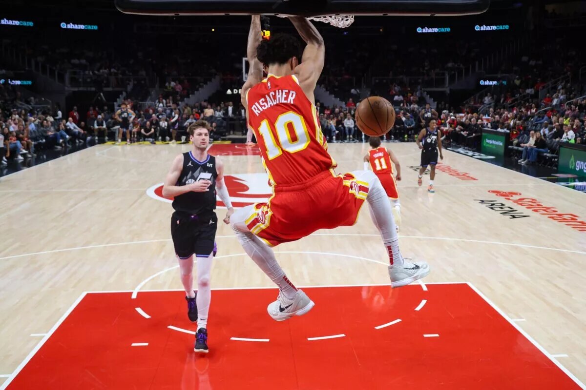 Atlanta Hawks rookie Zaccharie Risacher dunks in front of Utah Jazz rookie Kyle Filipowski