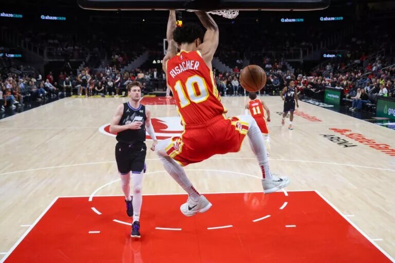 Atlanta Hawks rookie Zaccharie Risacher dunks in front of Utah Jazz rookie Kyle Filipowski