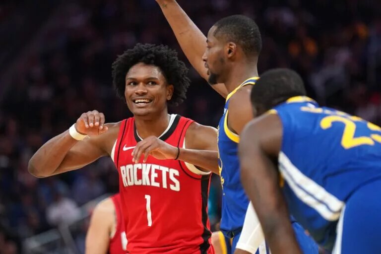 Houston Rockets point-forward Amen Thompson talks to Golden State Warriors point-forward Draymond Green (NBA All-Defensive team candidates)