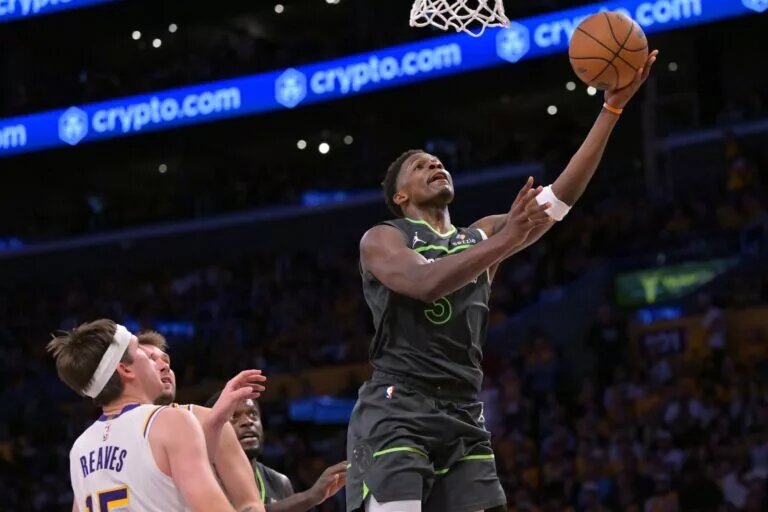 Apr 19, 2025; Los Angeles, California, USA; Minnesota Timberwolves guard Anthony Edwards (5) drives past Los Angeles Lakers guard Austin Reaves (15) in the second half at Crypto.com Arena. Mandatory Credit: Jayne Kamin-Oncea-Imagn Images