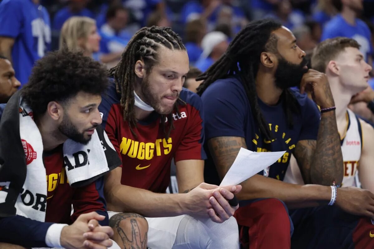 Denver Nuggets forward Aaron Gordon (32) looks over stats