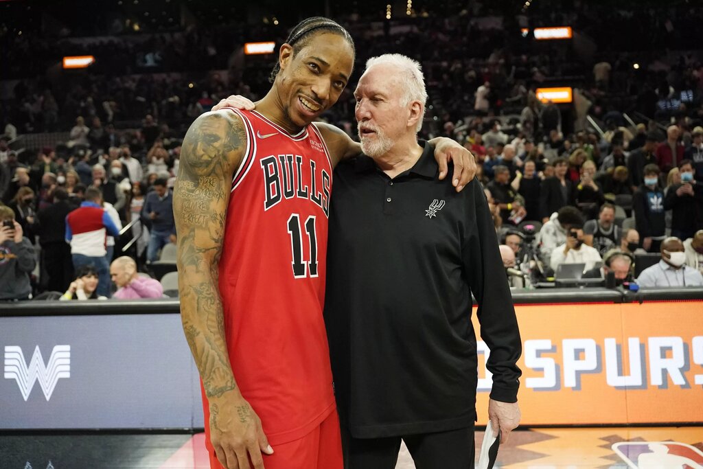 Chicago Bulls guard DeMar DeRozan (11) hugs San Antonio Spurs head coach Gregg Popovich 