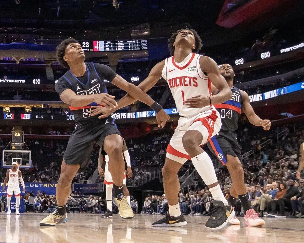 Detroit Pistons forward Ausar Thompson (9) battles for for the ball with his twin brother Houston Rockets forward Amen Thompson (1) 