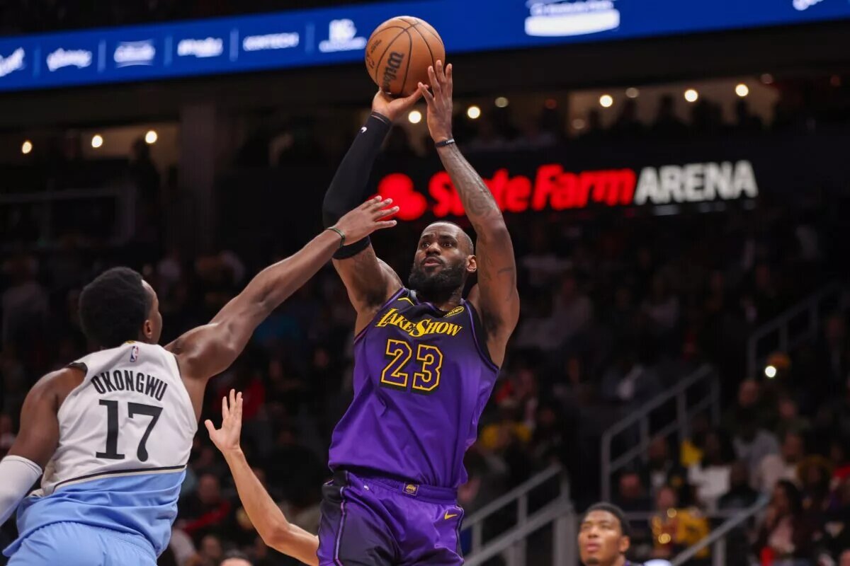Dec 6, 2024; Atlanta, Georgia, USA; Los Angeles Lakers forward LeBron James (23) shoots over Atlanta Hawks forward Onyeka Okongwu (17) in the second quarter at State Farm Arena. Mandatory Credit: Brett Davis-Imagn Images