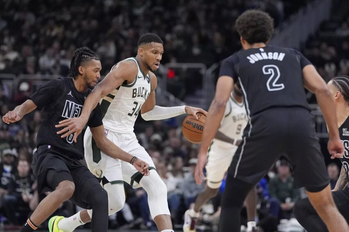 Milwaukee Bucks forward Giannis Antetokounmpo (34) brings the ball up the court against Brooklyn Nets guard De'Anthony Melton (8) in the first half at Fiserv Forum.
