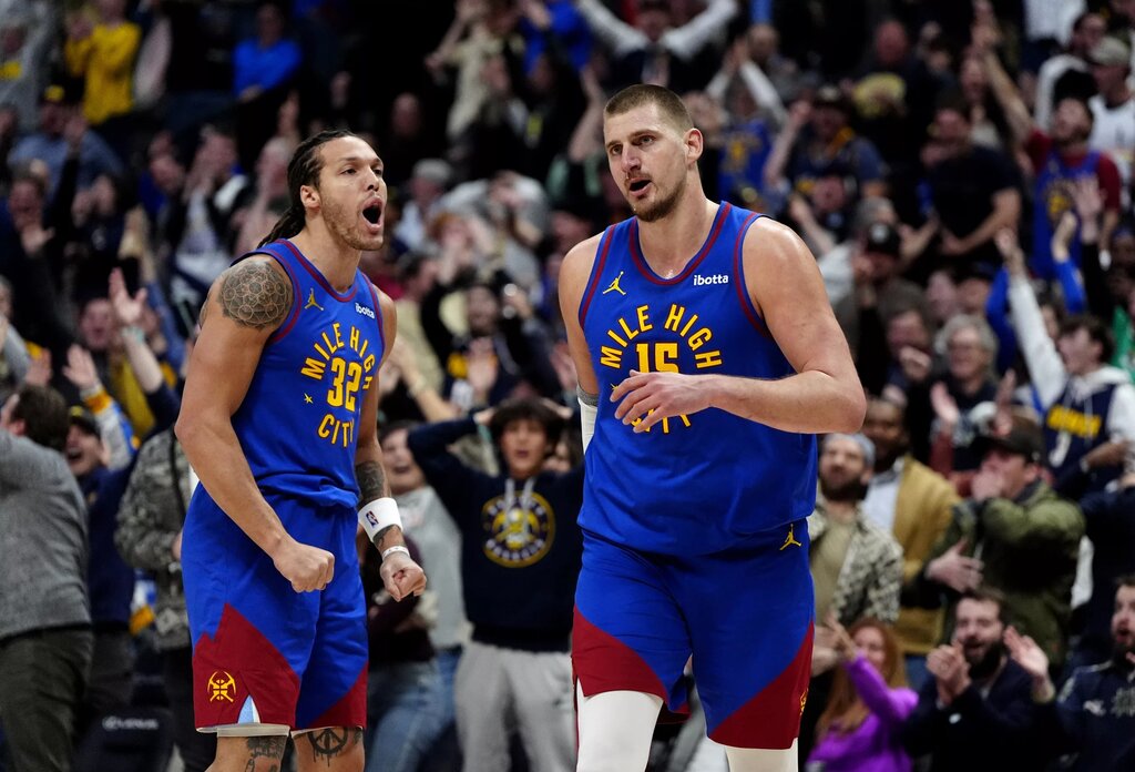 Denver Nuggets center Nikola Jokic (15) reacts along side forward Aaron Gordon 