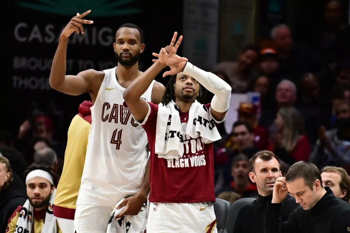 Cleveland Cavaliers forward Evan Mobley (4) and guard Darius Garland (10) celebrate after guard Sam Merrill (not pictured) hit a three point basket during the second half against the Dallas Mavericks at Rocket Mortgage FieldHouse.