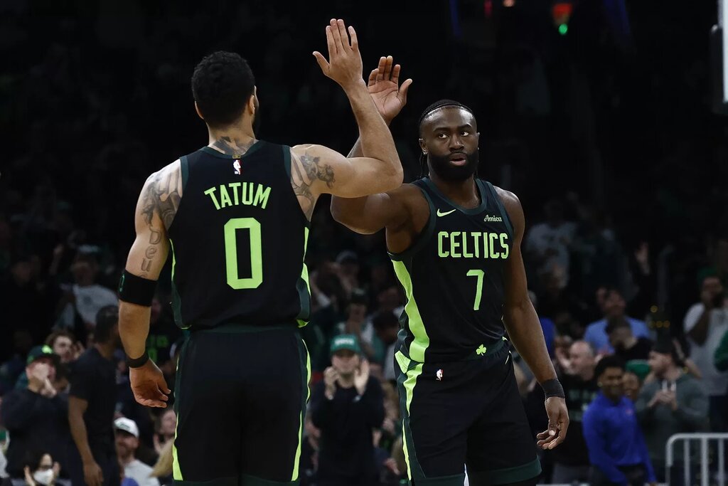 Boston Celtics guard Jaylen Brown (7) high fives forward Jayson Tatum 