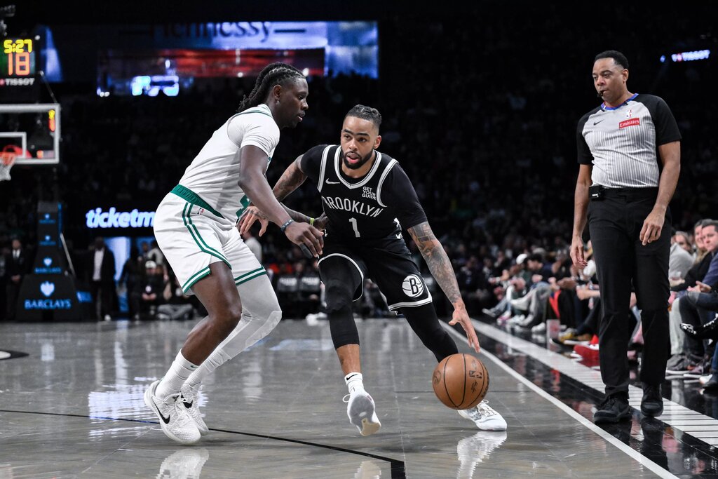 Brooklyn Nets guard D'Angelo Russell (1) drives to the basket while being defended by Boston Celtics guard Jrue Holiday (4) during the first half at Barclays Center.
